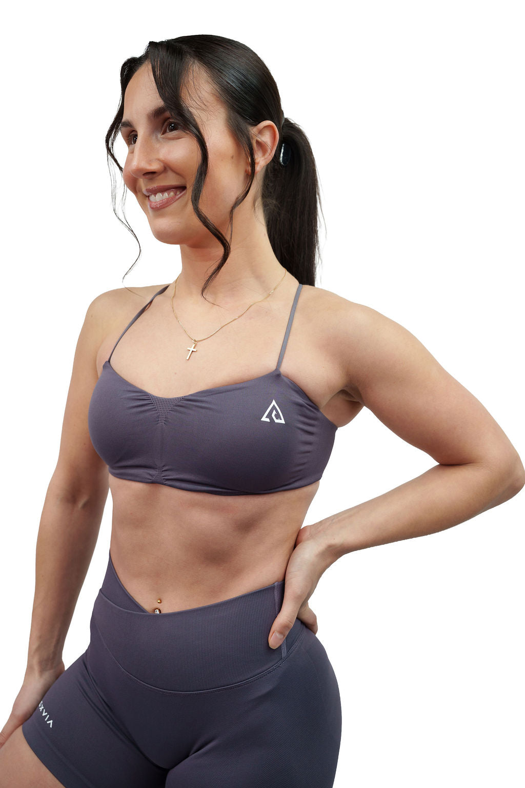 NOXVIA Ash Taupe sports bra, front detail showing the ruched neckline, slim straps and NOXVIA logo
