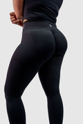 NOXVIA black sculpt leggings, back-side view showing the high-rise waistband, rear contour shaping and NOXVIA logo
