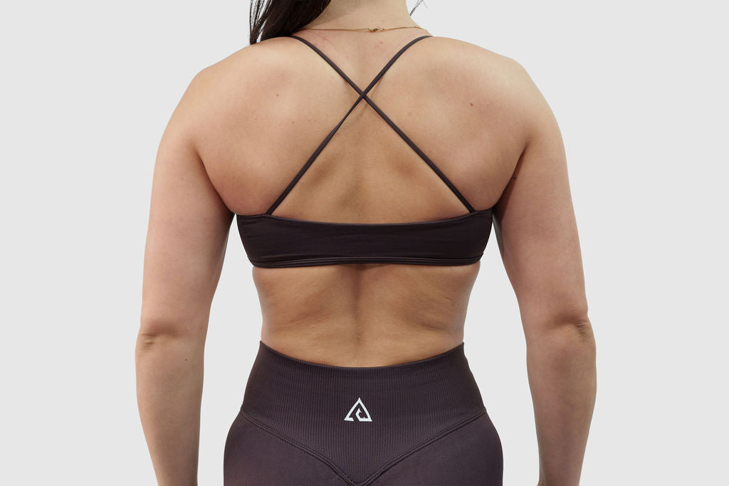 NOXVIA Iron Taupe sports bra, back detail showing the cross-back straps, open-back design and supportive underband

