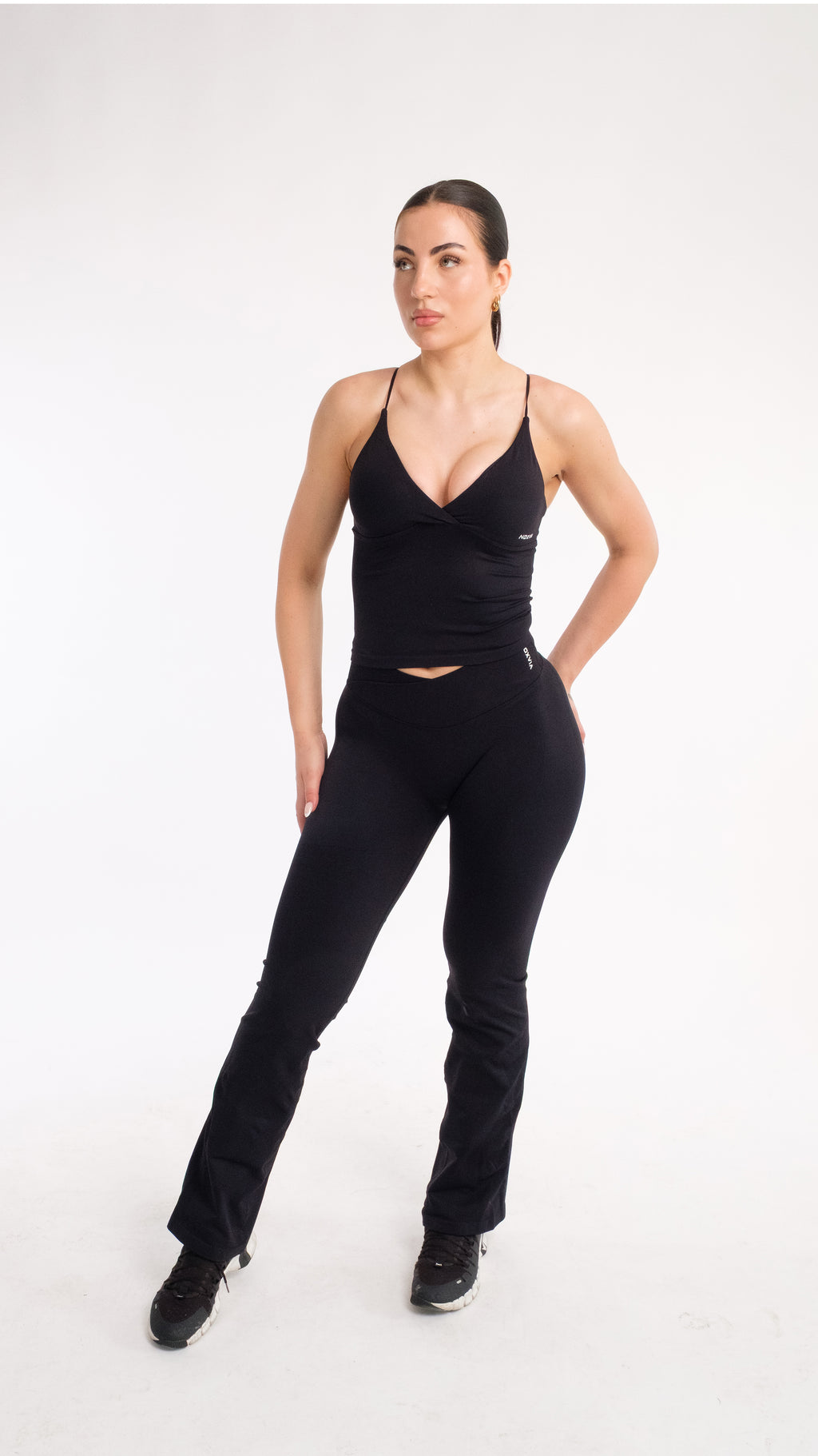 NOXVIA NOVA Open-Back Sculpt Top in Midnight Black, front view showing the sculpted twist-front neckline and longline fit
