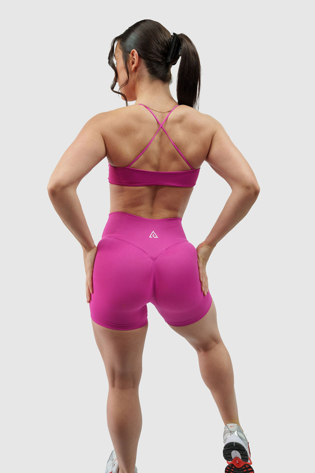 NOXVIA Nova Pink gym set, full back view showing the cross-back sports bra, high-rise sculpt shorts, rear contour shaping and NOXVIA logo
