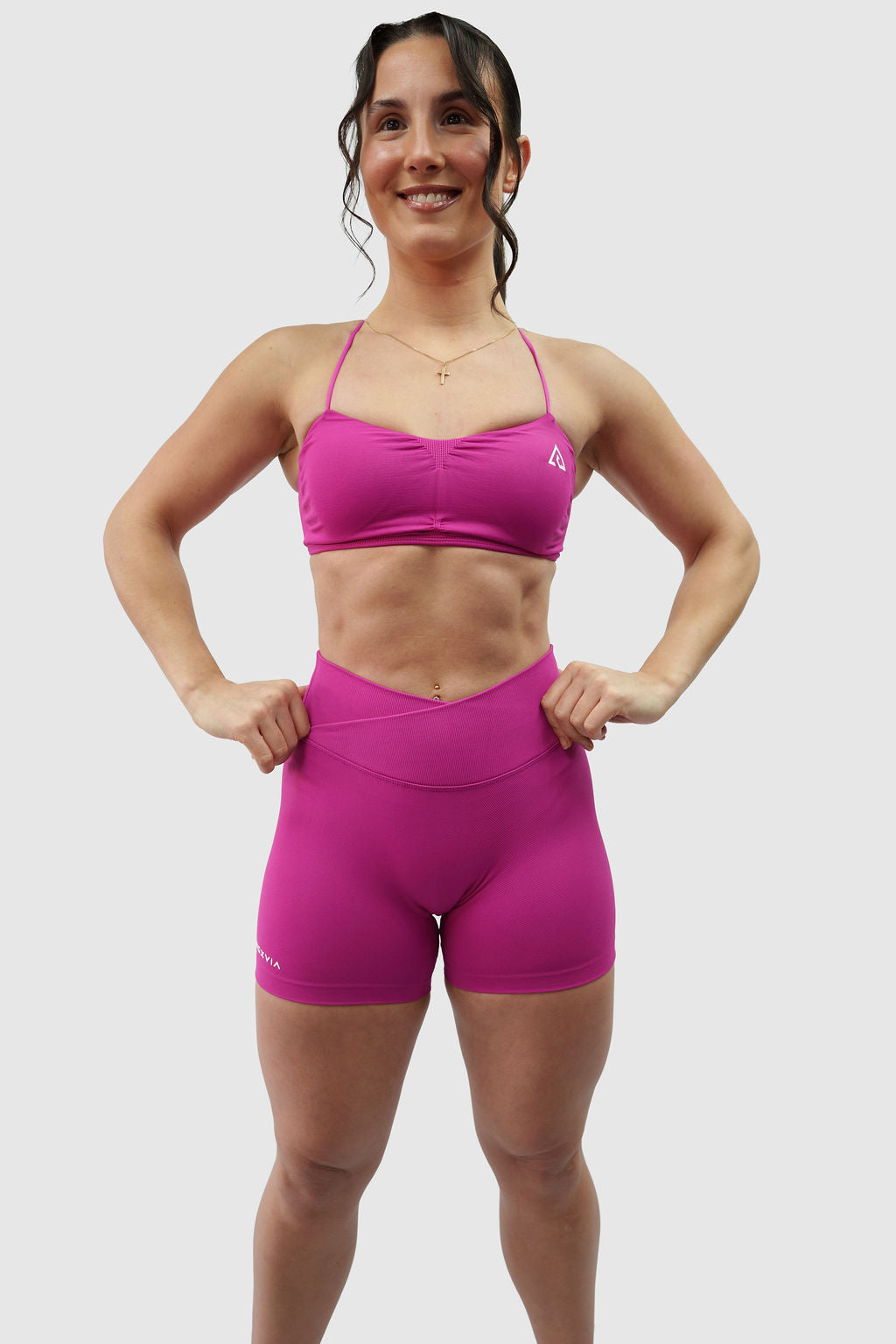 NOXVIA Nova Pink gym set, full front standing view showing the ruched sports bra, high-rise crossover sculpt shorts and NOXVIA branding
