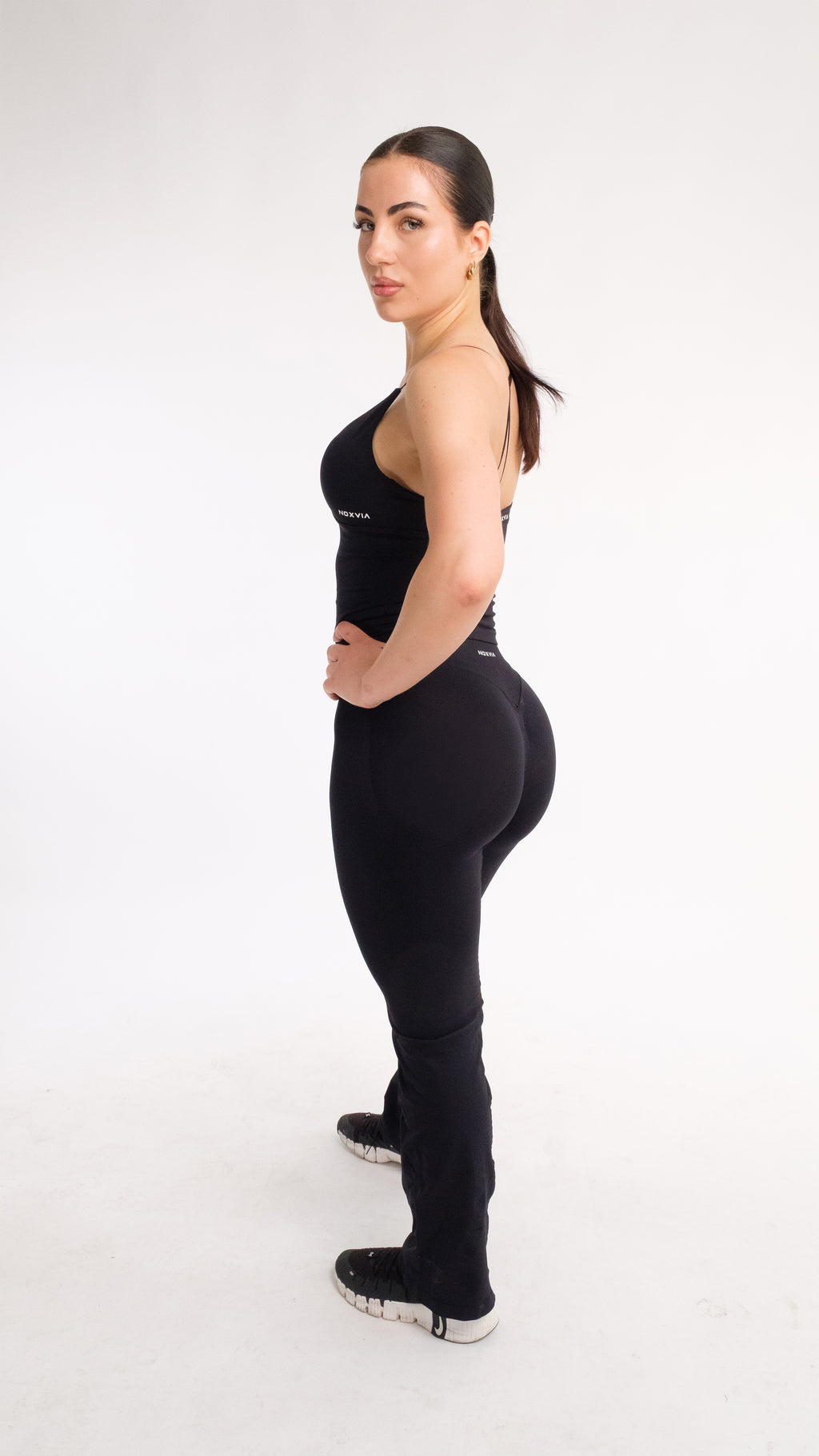 NOXVIA NOVA Sculpt Flare Leggings in Midnight Black, side view showing the sculpted fit and full-length flared leg