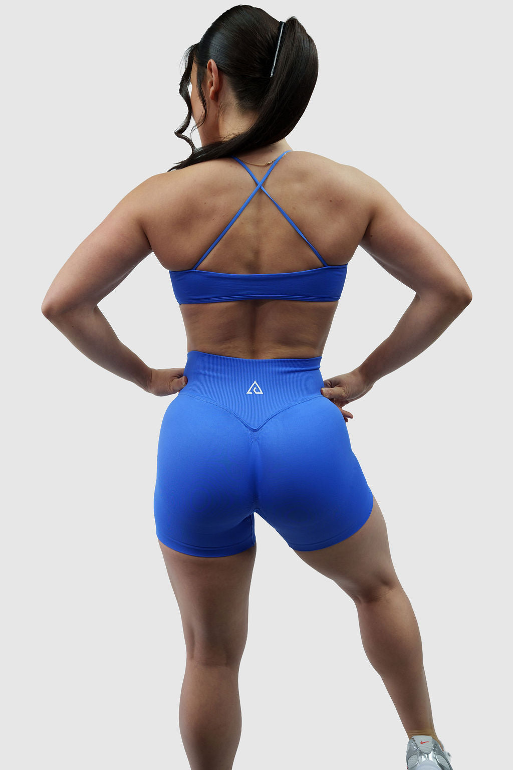 NOXVIA Royal Dominion blue gym set, full back view showing the cross-back sports bra, high-rise sculpt shorts, rear contour shaping and NOXVIA logo
