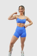 NOXVIA Royal Dominion blue gym set, front view showing the sports bra, high-rise crossover sculpt shorts and NOXVIA branding
